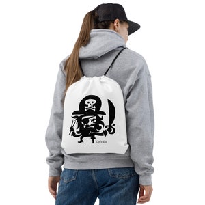 May include: White drawstring bag with a black cartoon pirate holding a sword and a skull and crossbones on his hat. The text "Cap'n Dee" is printed below the pirate.
