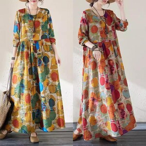 May include: Two long-sleeve dresses with a round neckline and a colorful polka dot pattern. The dresses are in shades of yellow, green, orange, and red. The dresses have a loose, flowing fit and are made of a lightweight fabric.