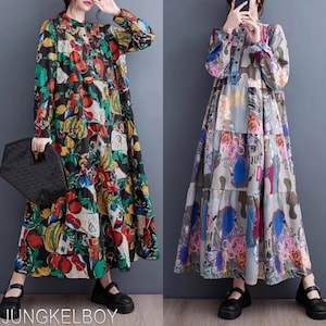 Puede incluir: Dos vestidos de manga larga con tops abotonados y faldas escalonadas. Uno presenta un fondo negro con un colorido estampado de frutas. El otro tiene un diseño de patchwork con formas abstractas en varios colores. Ambos vestidos se llevan con zapatos negros.