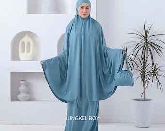 May include: A light blue prayer outfit with a matching bag. The outfit is made of a soft, comfortable fabric and has a loose, flowing fit. The bag is small and has a drawstring closure. The outfit is perfect for prayer or meditation.
