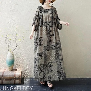 May include: A long, flowing dress with a paisley pattern in shades of gray and black. The dress has a round neckline and three-quarter sleeves. The text "JUNGKELBOY" is visible at the bottom of the image.