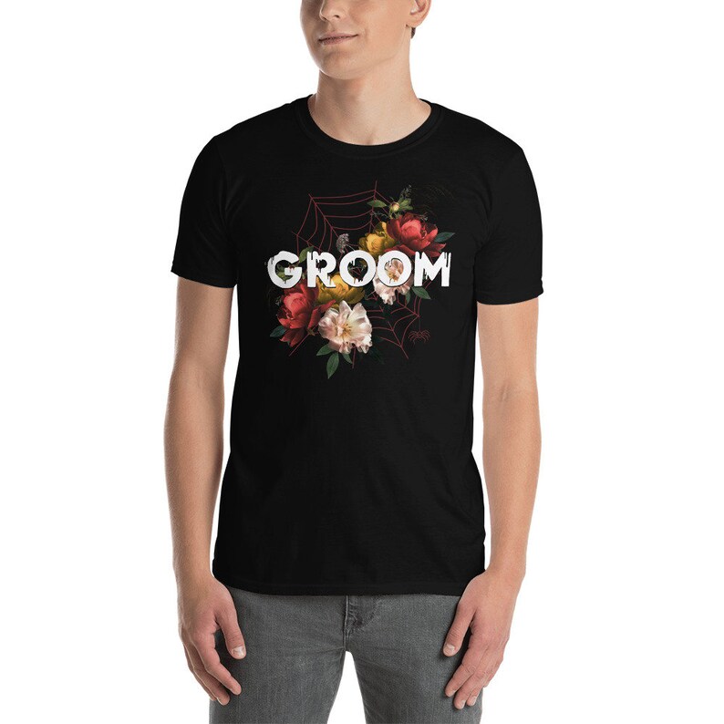 May include: Black t-shirt with a floral design and the word "GROOM" in white text.