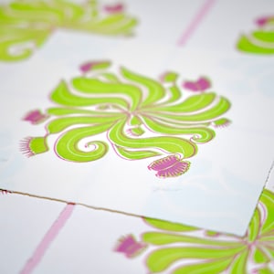 May include: A set of green and pink prints featuring a stylised floral design. The design is reminiscent of a carnivorous plant with a central flower and multiple tendrils.