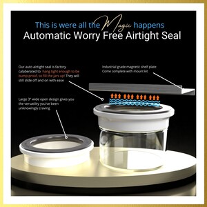 May include: A white glass jar with a black airtight seal. The seal is designed to be bump-proof and easy to remove. The jar is sitting on a wooden surface. The text "This is were all the Magic happens Automatic Worry Free Airtight Seal" is at the top of the image.