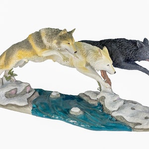 Three Wolves Jumping River Statue