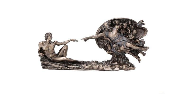 May include: A bronze-toned sculpture depicting the Creation of Adam, featuring two figures reaching toward each other with extended fingers. The piece shows a reclining figure on the left and a floating figure surrounded by drapery on the right.