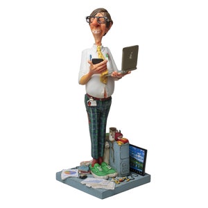 May include: A figurine of a man wearing glasses, a white shirt, a yellow tie, and plaid pants. He is holding a laptop and a cell phone. The figurine is standing on a base with a computer, papers, and other office supplies.