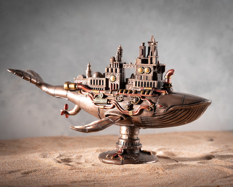 Op de afbeelding: Een steampunk-stijl walvisbeeld met ingewikkelde details, waaronder tandwielen, pijpen en een miniatuurstad op zijn rug. De walvis is gemaakt van metaal en heeft een bronzen afwerking.