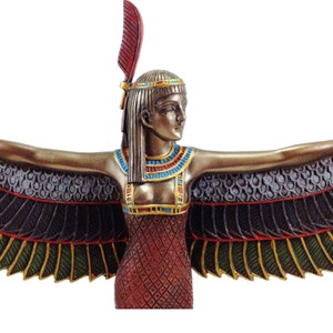 May include: A bronze statue of the Egyptian goddess Isis with outstretched wings. She is wearing a red dress with gold and blue accents and a headdress with a red feather.