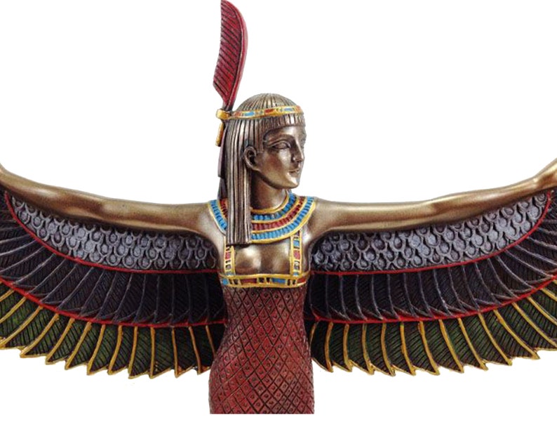 May include: A bronze statue of the Egyptian goddess Isis with outstretched wings. She is wearing a red dress with gold and blue accents and a headdress with a red feather.