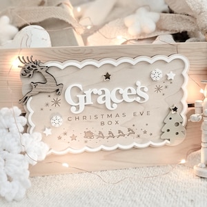 Personalised wooden Christmas crate with 3D white acrylic name plaque, sage green tree, oak reindeer, and festive details – ideal for Christmas Eve or advent gifts.