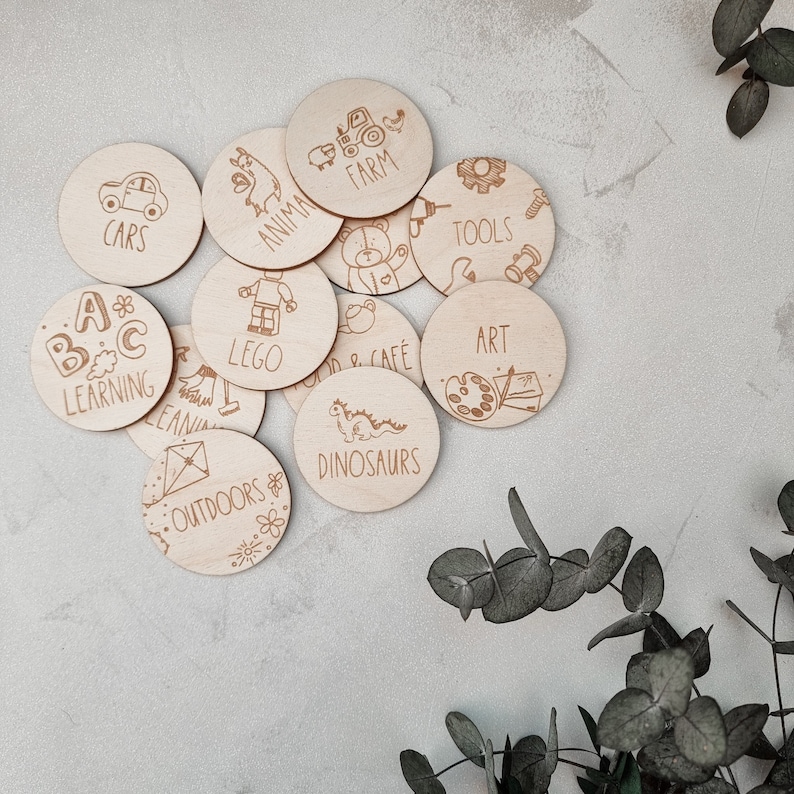 May include: Wooden circle learning toys with various themes, including cars, animals, farm, tools, art, LEGO, dinosaurs, outdoors, and ABC learning. Each circle features a unique design and text.