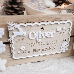 Maple wood plaque featuring 3D white name and gold-star tree design – perfect for festive December baskets or advent countdown crates.
