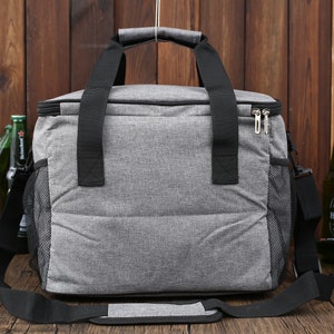 May include: A gray insulated cooler bag with black straps and a zipper closure. The bag has a mesh side pocket and a shoulder strap.