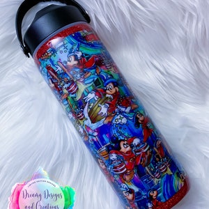 May include: A red and blue stainless steel tumbler with a handle. The tumbler is covered in a colorful print of Mickey Mouse and other Disney characters. The tumbler has a glitter finish and says "Dreamy Designs and Creations" on the bottom.