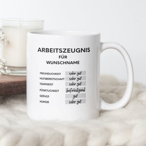 May include: White ceramic mug with a black and white design that says "Arbeitszeugnis für WUNSCHNAME" and lists various work qualities with ratings of "sehr gut", "gut", and "befriedigend".
