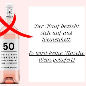 May include: A pink wine bottle with a white label that says "50" and "Deine Haut Braucht Jetzt Dringend Mehr Feuchtigkeit." The bottle is crossed out with a red X. The text "Der Kauf bezieht sich auf das Weinetikett. Es wird keine Flasche Wein geliefert!" is written in black on a white background.