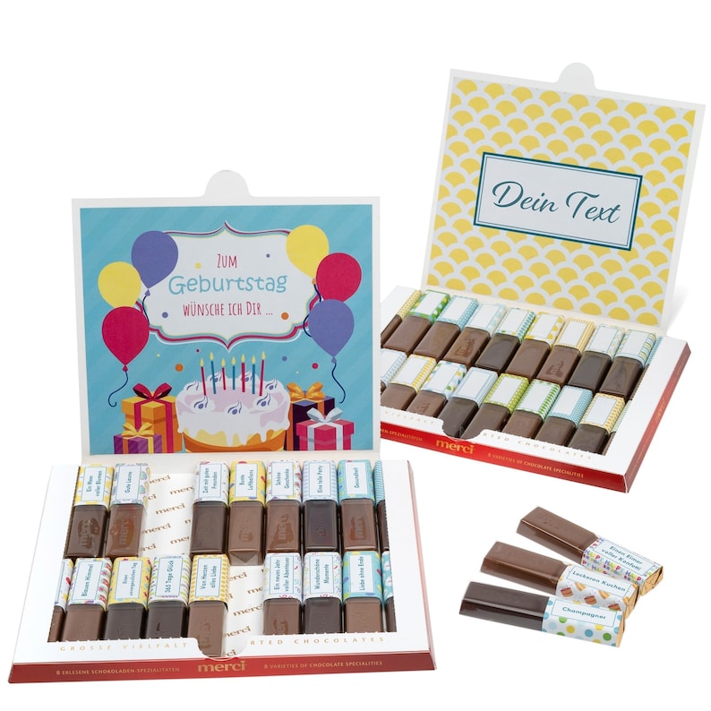 May include: A blue and white gift box with a birthday theme. The box contains assorted chocolate bars with colorful wrappers. The box lid has a personalized message that says "Zum Geburtstag w&uuml;nsche ich dir..." and the lid of the box has a space for a personalized message that says "Dein Text".