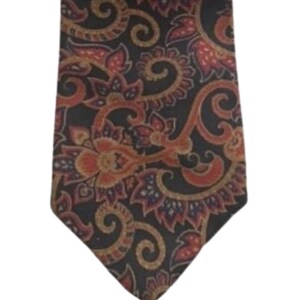 May include: A dark brown paisley patterned tie with red and gold accents.