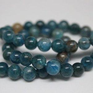 May include: A strand of blue apatite beads. The beads are round and have a smooth, polished finish.