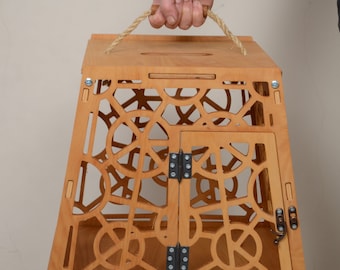 May include: A wooden pet carrier with a rope handle and a latched door. The carrier has a decorative pattern of circles and is made of light brown wood.