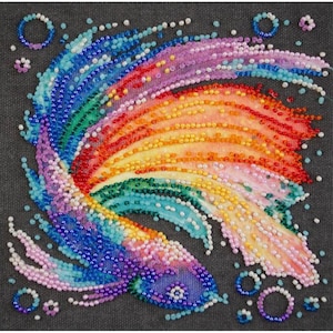 May include: A colourful beaded fish with a rainbow tail and blue, green, and purple scales. The fish is surrounded by small white beads and circles.