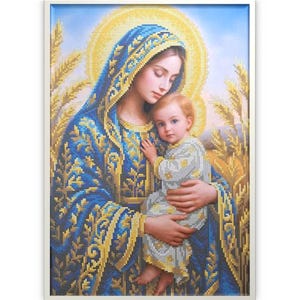 May include: A framed artwork depicting a woman in a blue robe holding a child. The woman has a golden halo and the child is wearing a white and yellow patterned garment. The artwork has a religious theme.