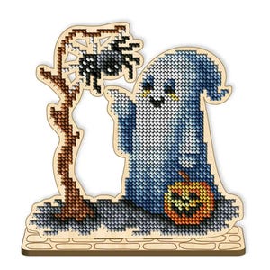 May include: A cross-stitch Halloween decoration featuring a blue ghost, a jack-o'-lantern, and a spider on a wooden base. The ghost is pointing, and the spider is on a wooden branch. The design is made with various shades of blue, orange, and black.