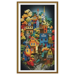 May include: A colorful illustration of a village nestled in a forest. The houses are painted in shades of blue, yellow, orange, and green. The trees are a mix of green and red, and there is a path leading up to the village.