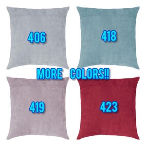 May include: Four square cushions in shades of grey, teal, mauve and burgundy, each with a different number: 406, 418, 419, and 423. The text "MORE COLORS!!" is also visible.