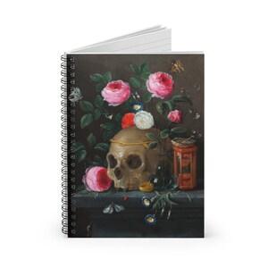 May include: Spiral-bound notebook featuring a still-life painting with a skull, roses, and butterflies. The artwork has a dark background with a skull adorned with a gold crown, surrounded by pink and white roses, and a small hourglass.