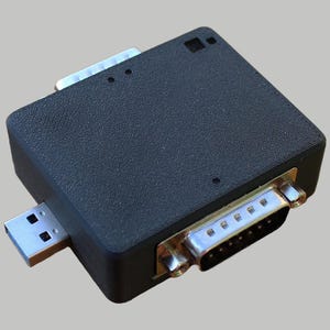 May include: A black USB to serial adapter with a 9-pin male connector on one end and a USB type A connector on the other end.