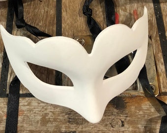 May include: A white masquerade mask with a simple design and eye cutouts. The mask is made of a smooth, lightweight material and has a black ribbon attached for tying.