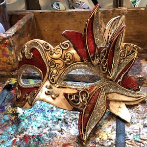 Elegant eye-mask decorated with sumptuous golden baroque decorations - Venetian mask with floral Venetian decorations