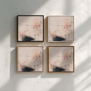 May include: Four framed abstract art prints. Each square print features a neutral background with a dark, cloud-like shape at the bottom, a red dot, and thin black lines. The frames are black, white, and gold.
