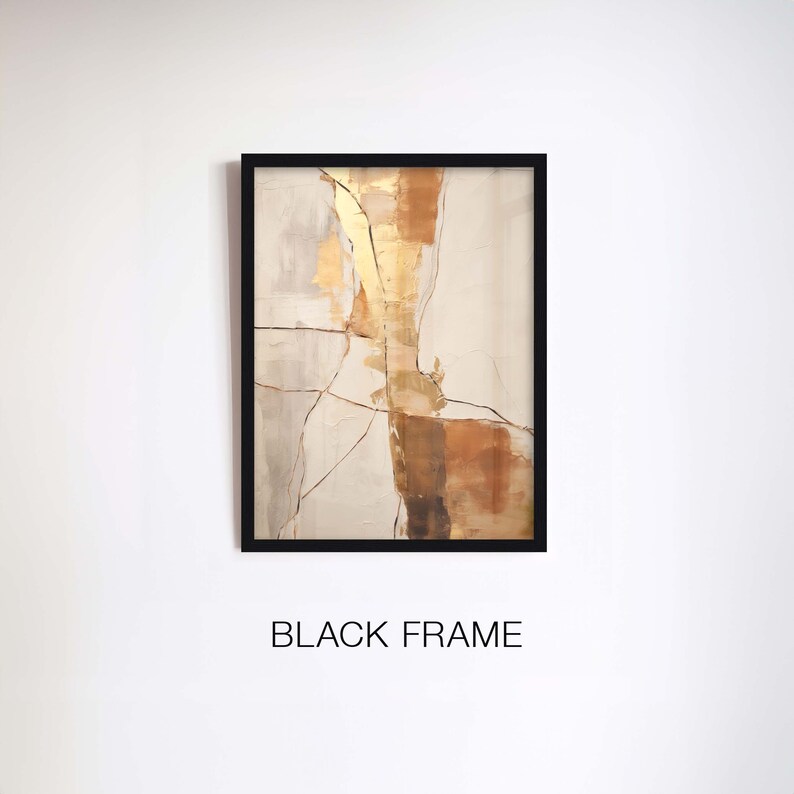 May include: Abstract painting with gold, brown, and white colours on a canvas with a black frame. The painting has a textured look and features a geometric design.