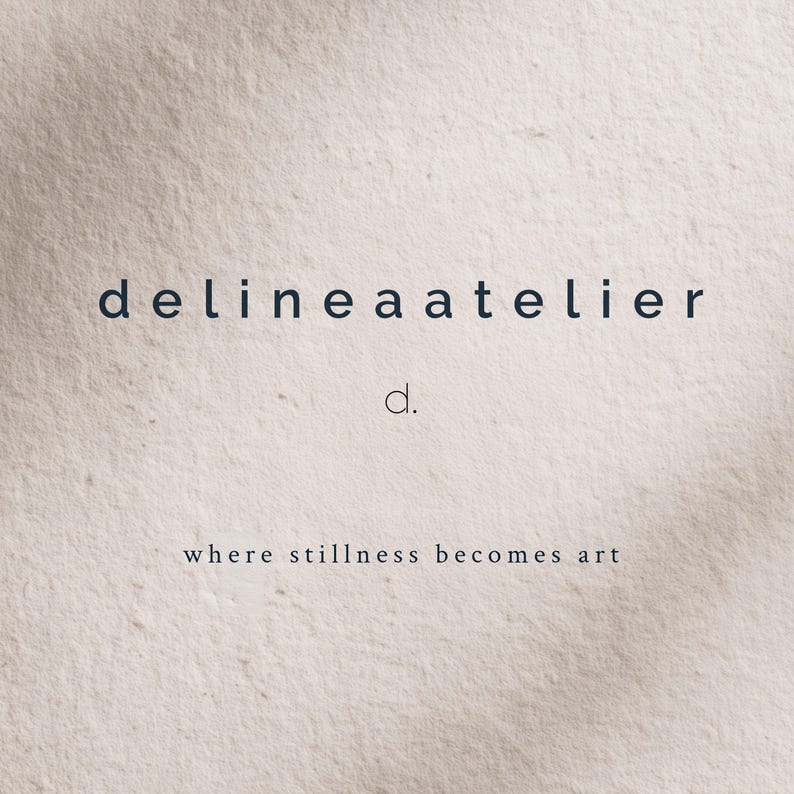 May include: A minimalist design featuring the text "delineaatelier" in a dark blue font, with a smaller "d." beneath it. The phrase "where stillness becomes art" is below, all set against a textured, off-white background.