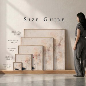 May include: A size guide displays five framed abstract art prints. The prints vary in size, from 10x10 inches to 55x55 inches, with measurements in both inches and centimeters. The artwork features a neutral color palette with red and black accents.