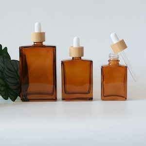1oz 30ml 50ml 100ml Flacone contagocce quadrato in vetro ambrato trasparente con tappo in legno di bambù naturale Siero Olio essenziale alle erbe Bottiglia per la cura della pelle all'ingrosso