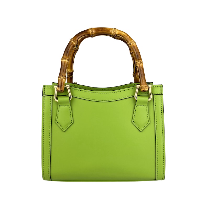 May include: A bright green leather handbag with a bamboo top handle. The bag has a structured shape and gold hardware.