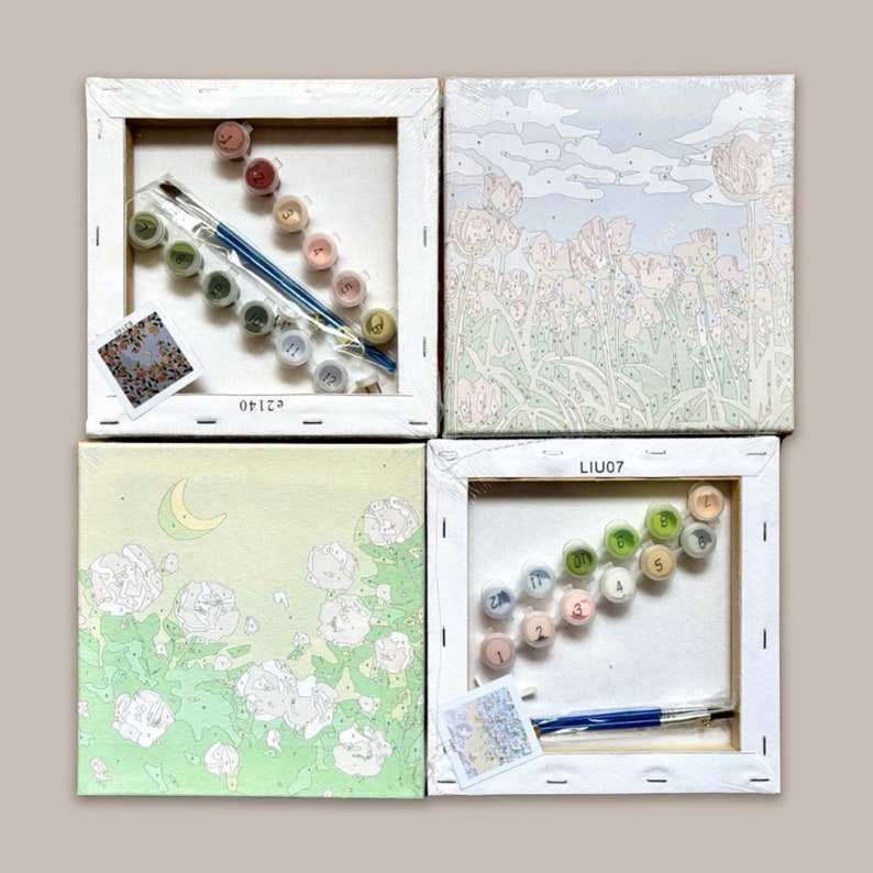 May include: Four paint by numbers kits featuring different designs. Each kit includes a canvas, paints, and brushes. The designs include a moon and flowers, a field of flowers, a field of flowers, and a field of flowers. The kits are labelled with the numbers 62140, LIU07, and LIU07.