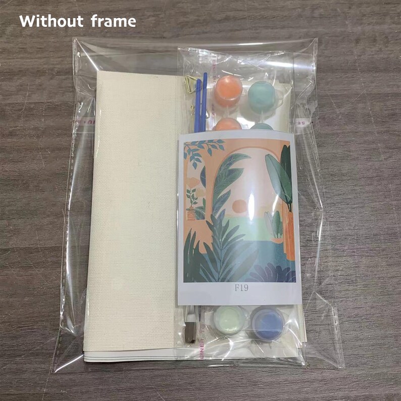 May include: A paint by numbers kit with a canvas, brushes, and paint pots. The image on the canvas is a colorful abstract design with an archway and foliage. The paint pots are labeled F19.
