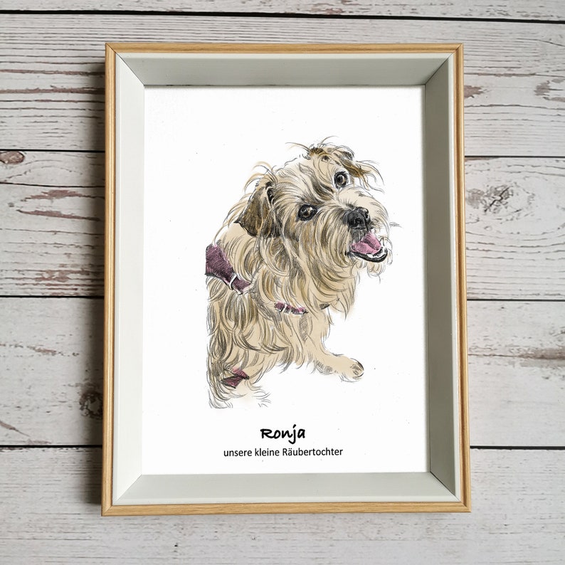 May include: A framed illustration of a brown and white dog with a pink collar. The dog is looking to the right and has its mouth slightly open. The text "Ronja unsere kleine R&auml;ubertochter" is printed below the dog.
