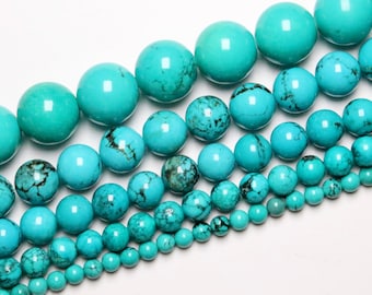 May include: A collection of turquoise beads in various sizes, ranging from small to large. The beads are a vibrant blue-green color and have a smooth, polished finish.