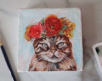 A painting of a cute tabby cat with an adorable flower crown.Acrylic portrait of a cute cat 5"/5" inch stretched canvas.