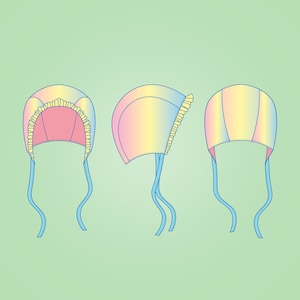 Peut inclure: Trois vues d'un bonnet de b&eacute;b&eacute; avec un motif ombr&eacute; arc-en-ciel et une bordure de dentelle jaune. Le bonnet a des liens bleus.