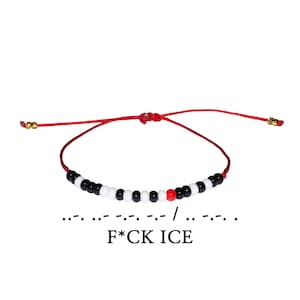 May include: Red string bracelet with black, white, and red beads. The bracelet spells out "F*CK ICE" in Morse code. The bracelet is adjustable and has gold-colored metal accents.