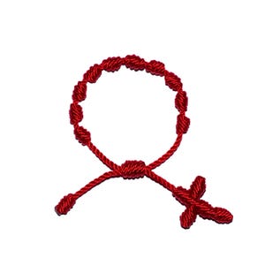May include: A red knotted bracelet with a small red cross charm.