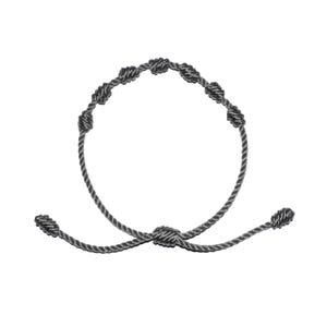 May include: A gray knotted bracelet with an adjustable sliding knot closure. The bracelet features seven evenly spaced knots along the circular portion. The cord is a twisted rope style. The bracelet is shown against a white background.
