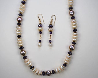 May include: A pearl and amethyst necklace and earrings set. The necklace is made with white pearls, purple amethyst beads, and gold accents. The earrings are dangle earrings with a similar design.